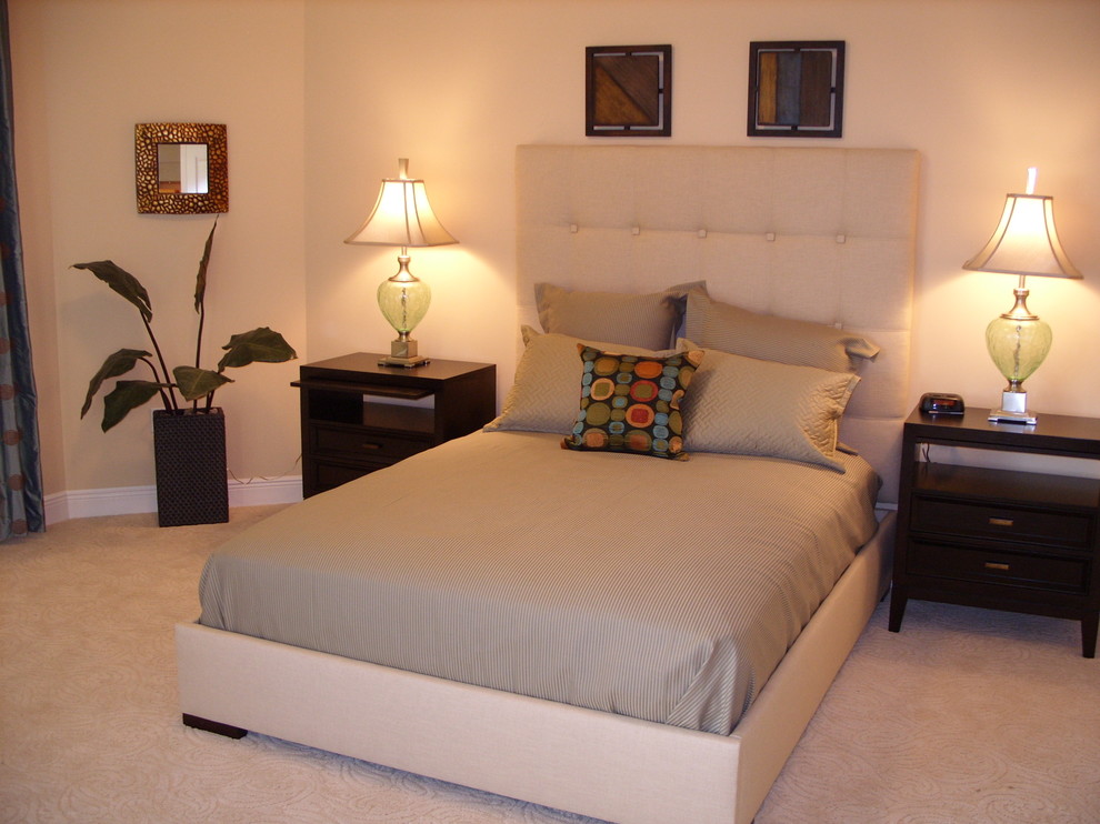 Photo of a small contemporary guest bedroom in Miami with beige walls, carpet, no fireplace and beige floor.