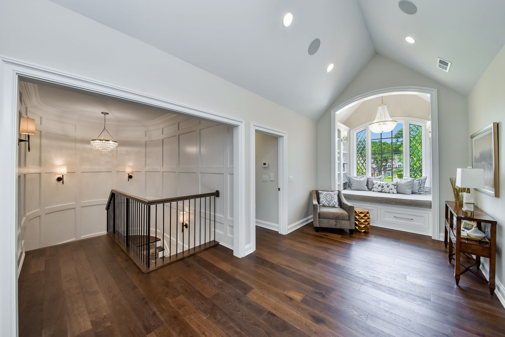 Design ideas for a mid-sized transitional hallway in Chicago with white walls, dark hardwood floors and vaulted.