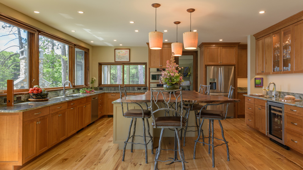 Inspiration for a country u-shaped kitchen in Boston with shaker cabinets, medium wood cabinets, green splashback, stainless steel appliances, medium hardwood floors, with island, brown floor and green benchtop.