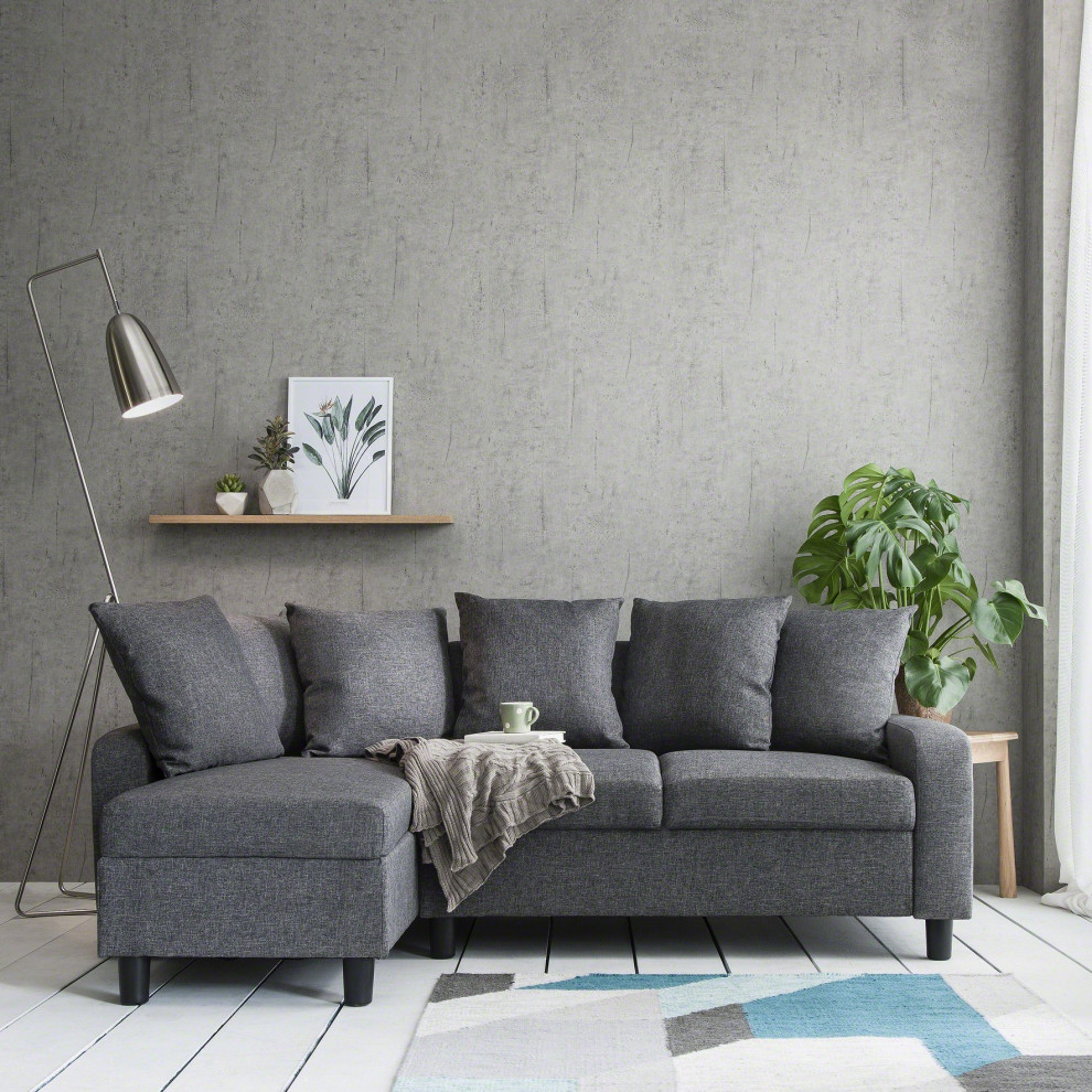 Modern inredning av ett litet vardagsrum, med grå väggar, ljust trägolv och vitt golv