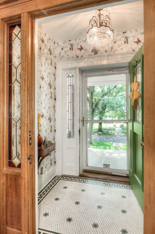 Photo of a small traditional foyer in Omaha with porcelain floors, a single front door, a green front door and wallpaper.