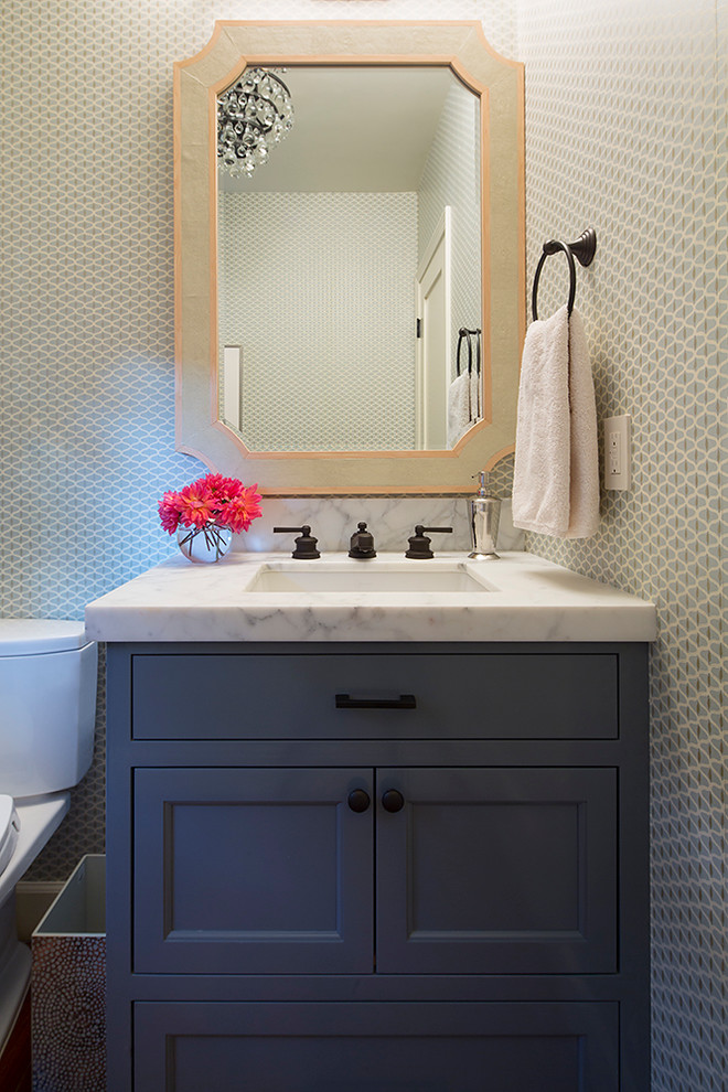 Inspiration for a small transitional powder room in San Francisco with grey cabinets, an undermount sink, marble benchtops, a two-piece toilet and recessed-panel cabinets.