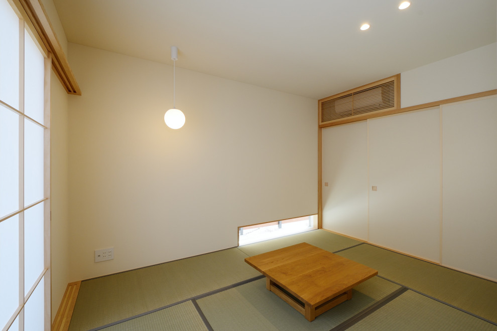 Example of a mid-sized zen enclosed tatami floor, green floor, wallpaper ceiling and wallpaper family room design in Other with white walls, no fireplace and a tv stand