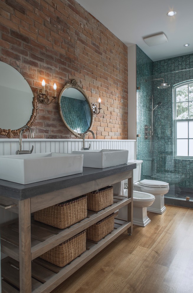 Large industrial master bathroom in Toronto with concrete benchtops, open cabinets, brown cabinets, an alcove shower, a two-piece toilet, gray tile, ceramic tile, white walls, mosaic tile floors, a vessel sink, a claw-foot tub and brown floor.
