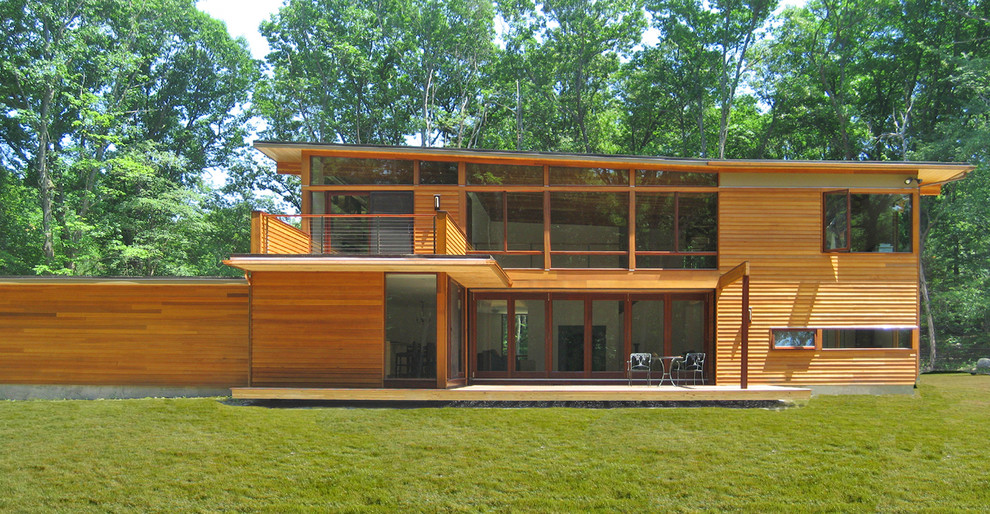 Large contemporary two-storey house exterior in Boston with wood siding and a flat roof.