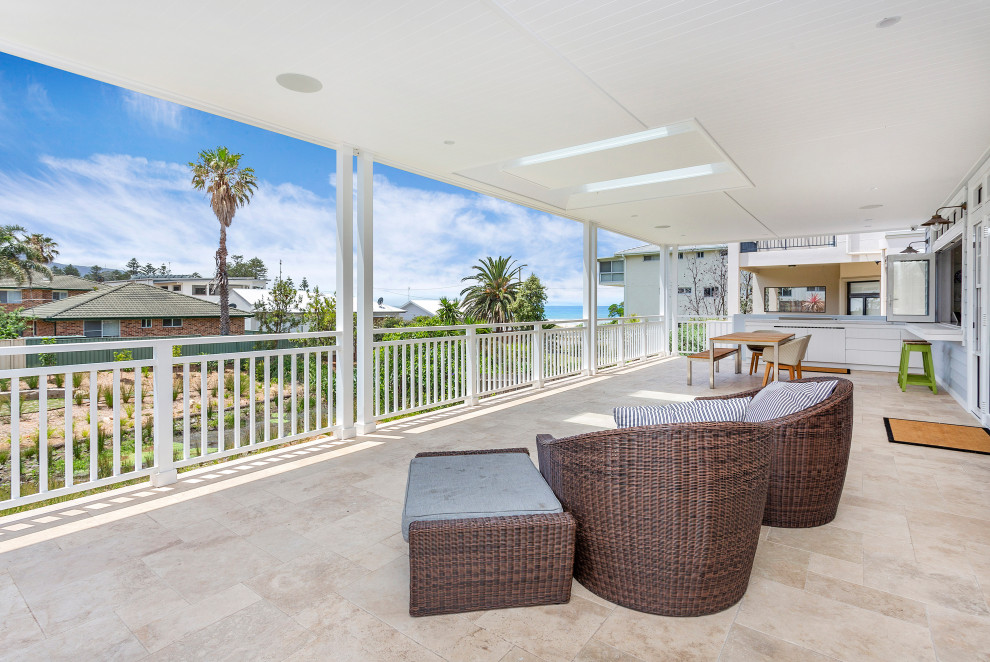Inspiration for a large beach style backyard patio in Wollongong with an outdoor kitchen, tile and a roof extension.