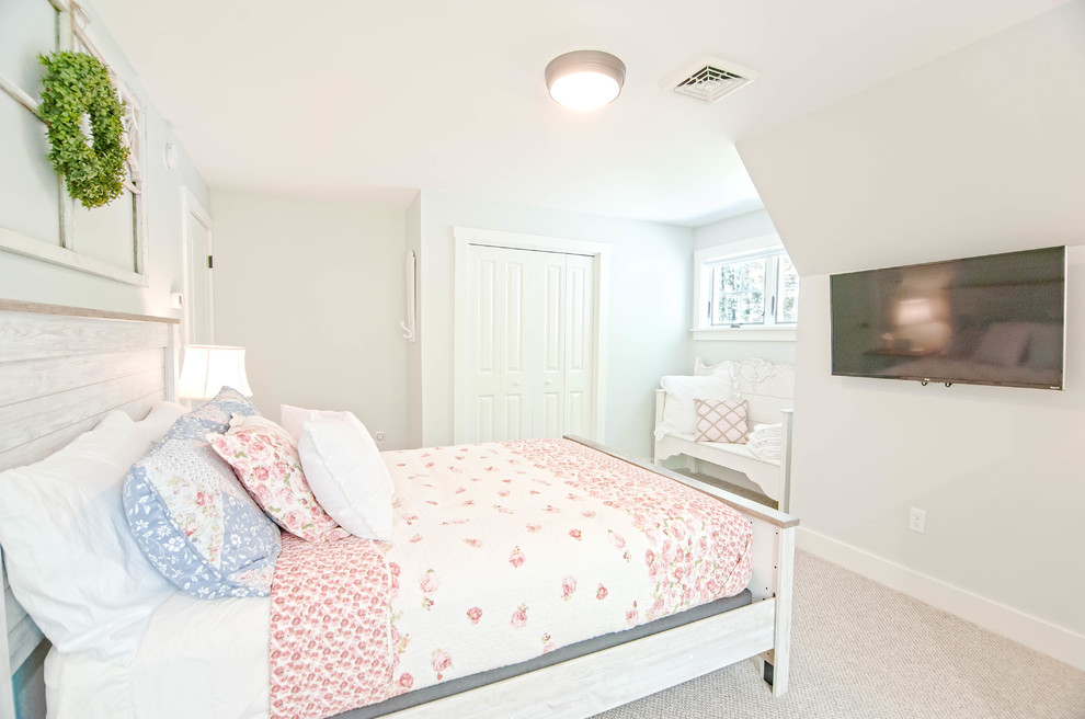 Design ideas for a mid-sized arts and crafts guest bedroom in Portland Maine with blue walls, carpet and beige floor.