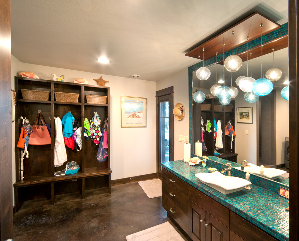 Mountain style kids' bathroom photo with a vessel sink, raised-panel cabinets, dark wood cabinets and tile countertops