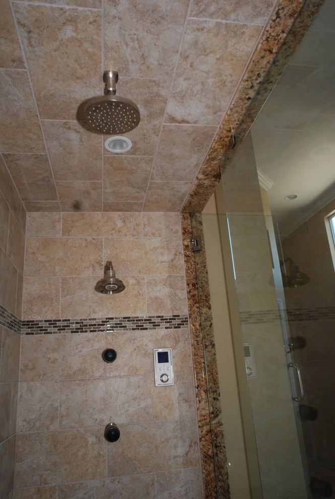 Photo of an expansive traditional master bathroom in Orange County with an undermount sink, raised-panel cabinets, distressed cabinets, granite benchtops, a drop-in tub, an alcove shower, a two-piece toilet, beige tile, porcelain tile, beige walls and porcelain floors.