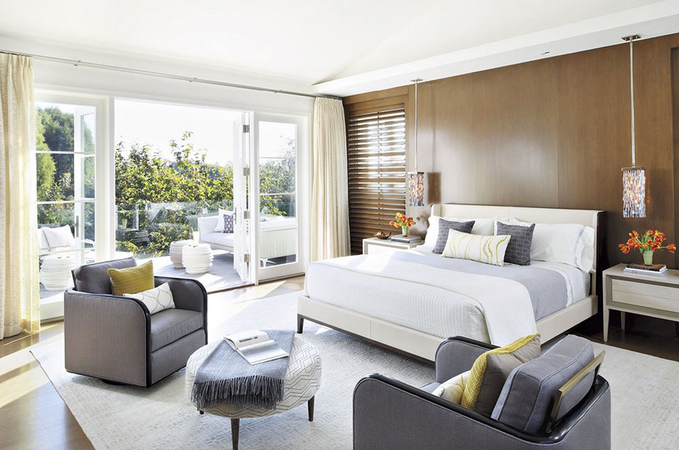 This is an example of a contemporary bedroom in Los Angeles with white walls and dark hardwood floors.