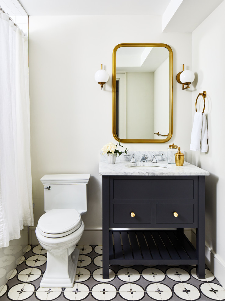 Inspiration for a small transitional 3/4 bathroom in Los Angeles with flat-panel cabinets, black cabinets, an alcove tub, a shower/bathtub combo, a two-piece toilet, white walls, ceramic floors, an undermount sink, marble benchtops, grey floor, a shower curtain and grey benchtops.