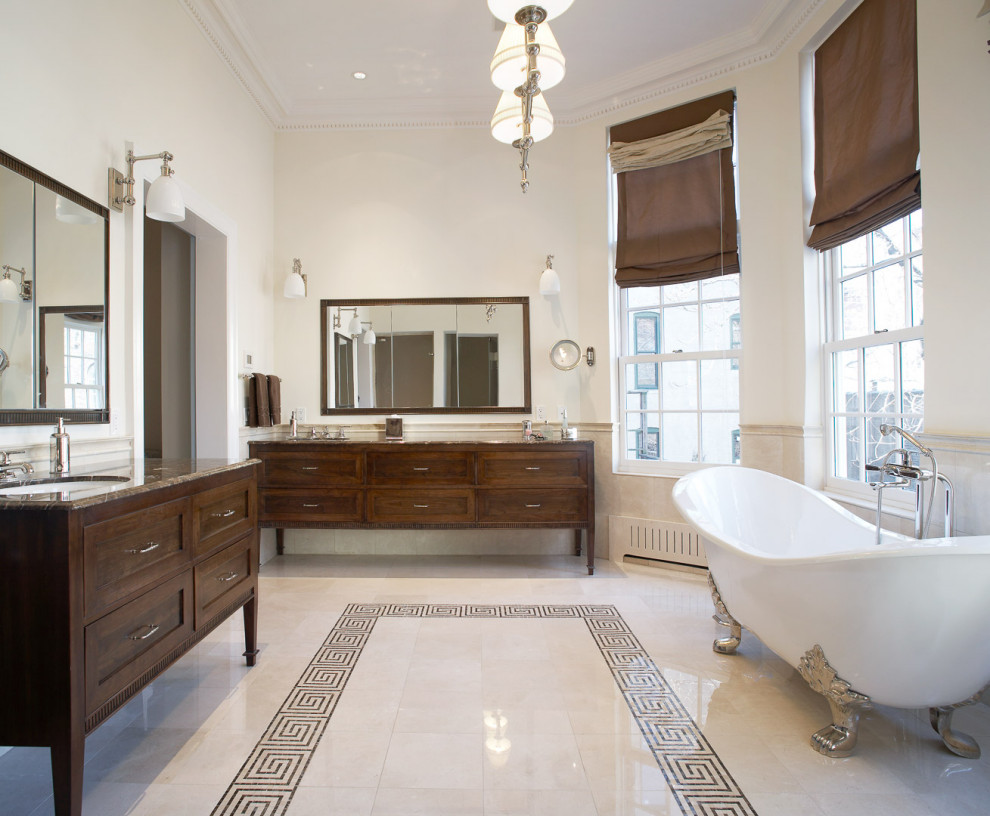 This is an example of a large transitional master bathroom in New York with shaker cabinets, medium wood cabinets, a claw-foot tub, an alcove shower, a one-piece toilet, beige tile, stone tile, beige walls, mosaic tile floors, a drop-in sink, granite benchtops, multi-coloured floor, a hinged shower door, multi-coloured benchtops, an enclosed toilet, a double vanity, a freestanding vanity and exposed beam.