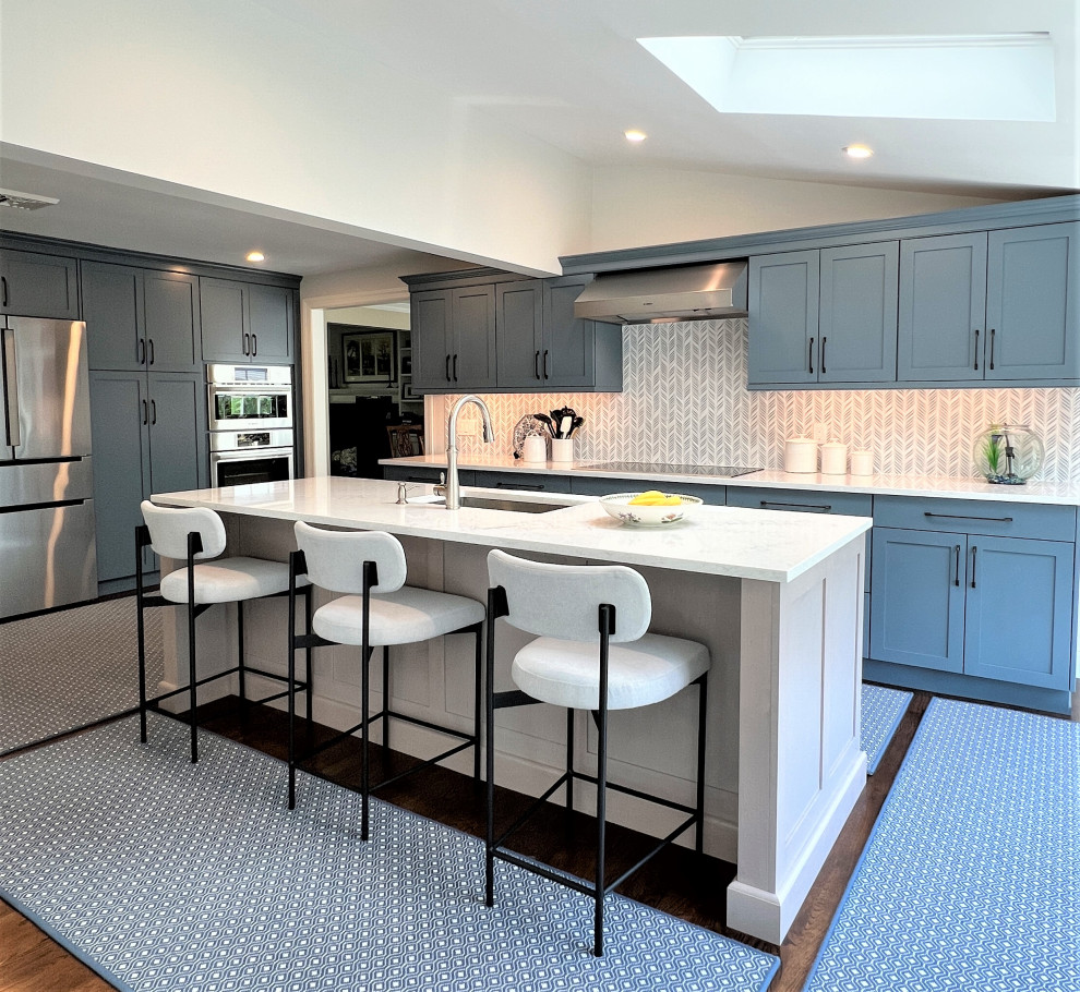 Transitional kitchen photo in New York with shaker cabinets, blue cabinets and stainless steel appliances
