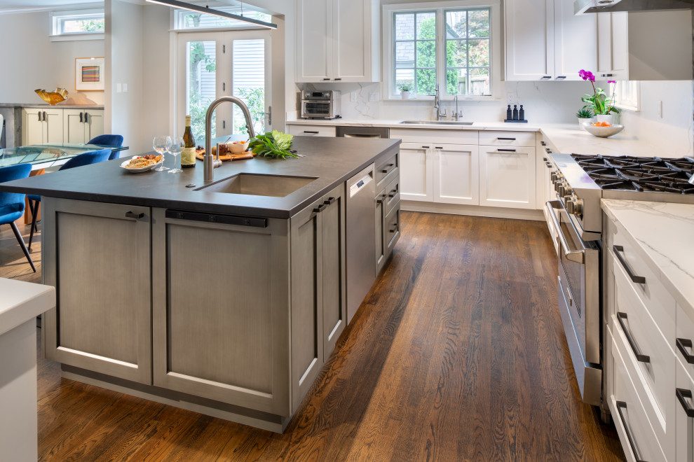 Transitional l-shaped eat-in kitchen photo in DC Metro with recessed-panel cabinets, marble backsplash and an island