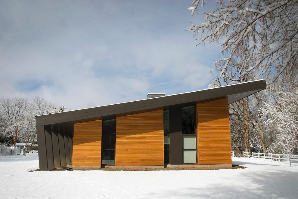 This is an example of a contemporary exterior in Salt Lake City with wood siding and a shed roof.