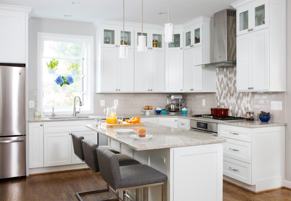 Photo of a large transitional l-shaped open plan kitchen in DC Metro with recessed-panel cabinets, white cabinets, marble benchtops, multi-coloured splashback, stone tile splashback, stainless steel appliances, with island, an undermount sink and dark hardwood floors.