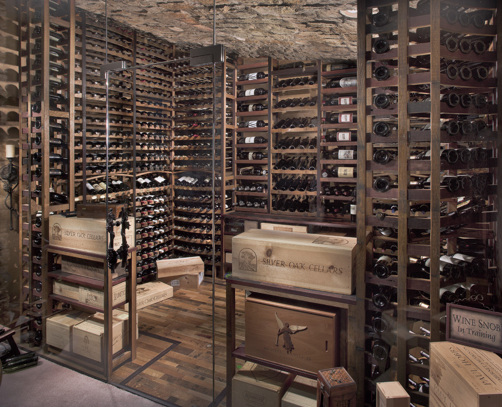 This is an example of a large country wine cellar in Phoenix with medium hardwood floors, storage racks and brown floor.
