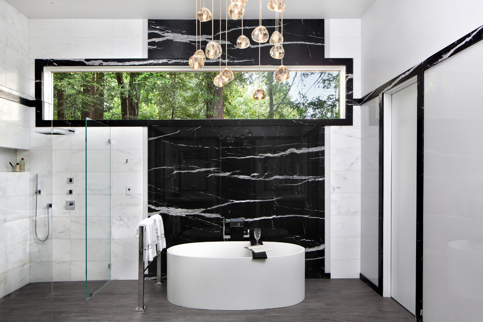 Design ideas for a mid-sized contemporary master bathroom in San Francisco with flat-panel cabinets, white cabinets, a freestanding tub, an alcove shower, black tile, black and white tile, white tile, marble, white walls, porcelain floors, marble benchtops, brown floor, an open shower and an undermount sink.
