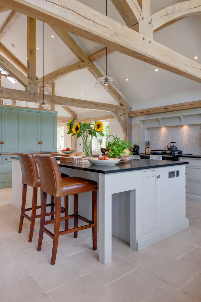 This is an example of a country kitchen in Other with shaker cabinets, white cabinets and with island.