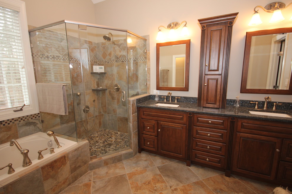 Traditional master bathroom in Raleigh with granite benchtops, porcelain tile and porcelain floors.