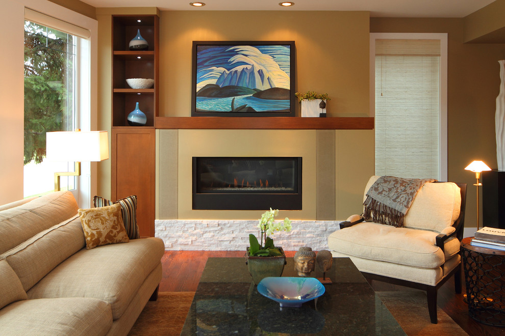 Photo of a mid-sized transitional open concept family room in Calgary with beige walls, medium hardwood floors, a ribbon fireplace and a stone fireplace surround.