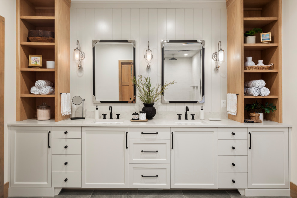 Inspiration for a large coastal master ceramic tile, gray floor, double-sink and shiplap wall bathroom remodel in Minneapolis with recessed-panel cabinets, white cabinets, a one-piece toilet, beige walls, an undermount sink, quartzite countertops, a hinged shower door, white countertops and a built-in vanity