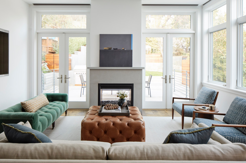 Inspiration for a large transitional formal living room in San Francisco with white walls, light hardwood floors, a wall-mounted tv and beige floor.
