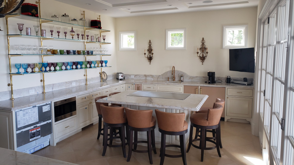 Inspiration for a large timeless u-shaped eat-in kitchen remodel in Orange County with an undermount sink, raised-panel cabinets, distressed cabinets, quartz countertops, stainless steel appliances and two islands