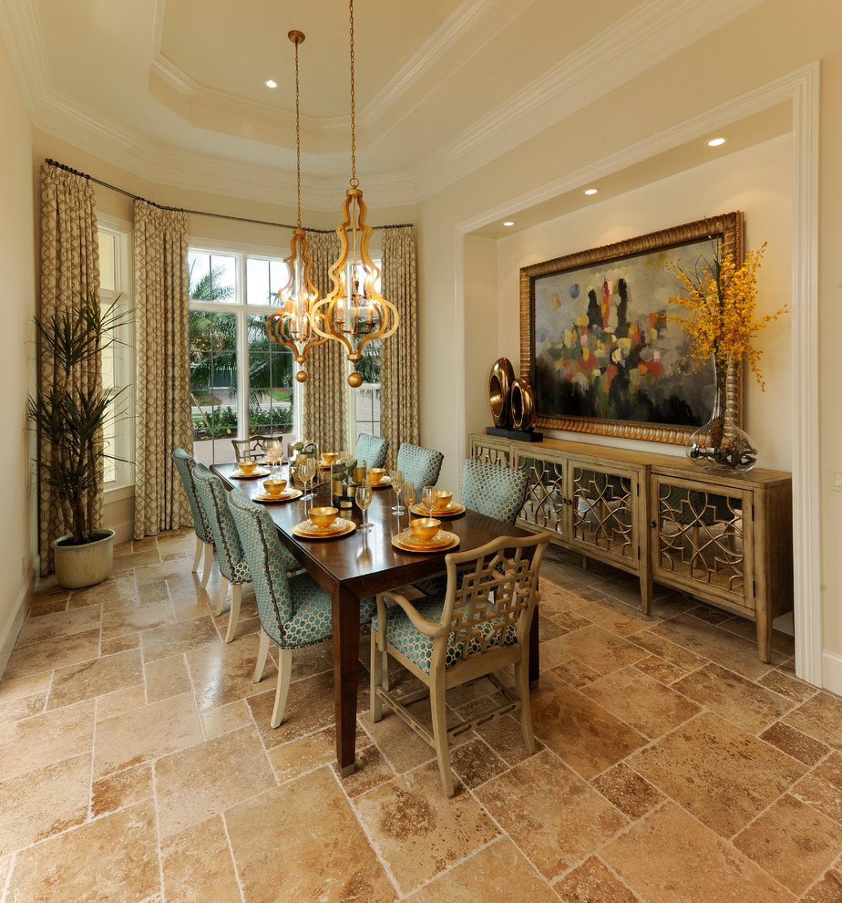 This is an example of a large mediterranean separate dining room in Miami with beige walls, travertine floors and no fireplace.