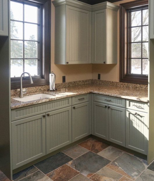 Inspiration for a mid-sized country l-shaped home bar in Detroit with an undermount sink, recessed-panel cabinets, green cabinets, granite benchtops and slate floors.