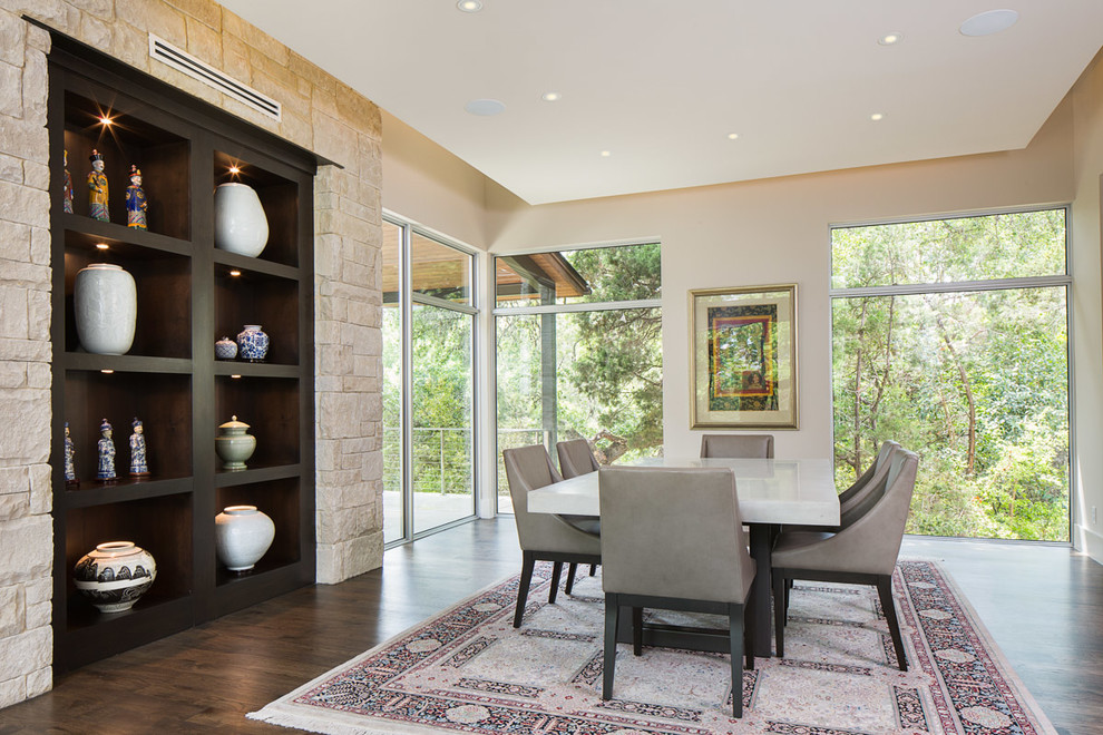 Inspiration for a contemporary dining room in Austin with beige walls and dark hardwood floors.
