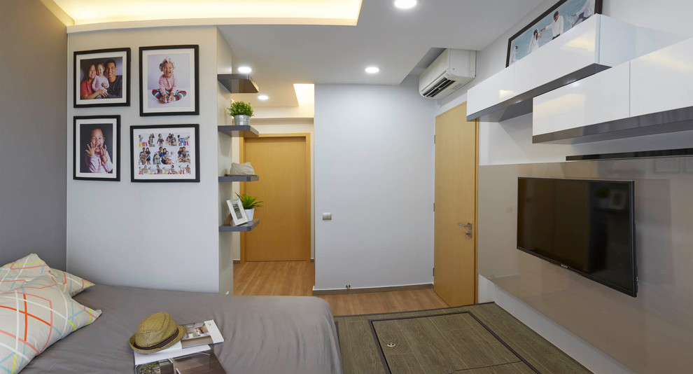 This is an example of a mid-sized contemporary master bedroom in Singapore with white walls.