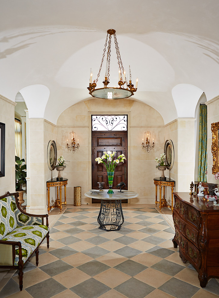 Design ideas for a large traditional foyer in Tampa with beige walls, porcelain floors, a single front door, a dark wood front door and multi-coloured floor.