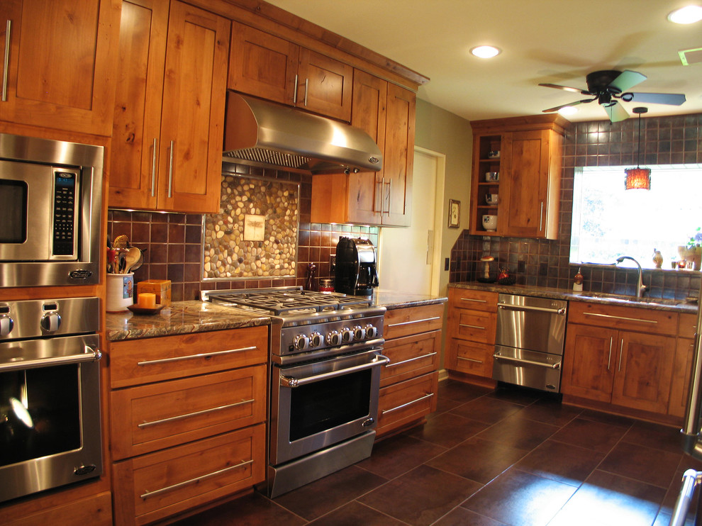 Example of a large transitional u-shaped eat-in kitchen design in New Orleans with a double-bowl sink, medium tone wood cabinets, marble countertops, brown backsplash, ceramic backsplash, stainless steel appliances and no island