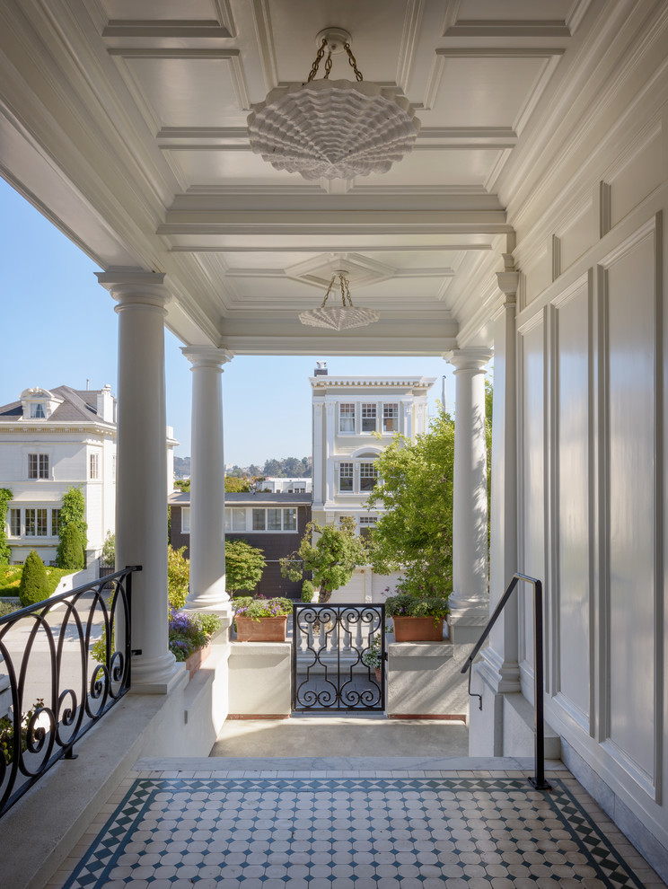 Design ideas for a mid-sized traditional front yard verandah in San Francisco with tile and a roof extension.
