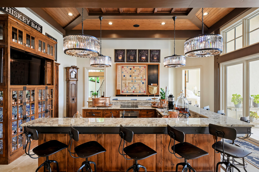 Inspiration for a mediterranean u-shaped seated home bar in Kansas City with beige floor, a drop-in sink, glass-front cabinets, medium wood cabinets, granite benchtops and beige benchtop.