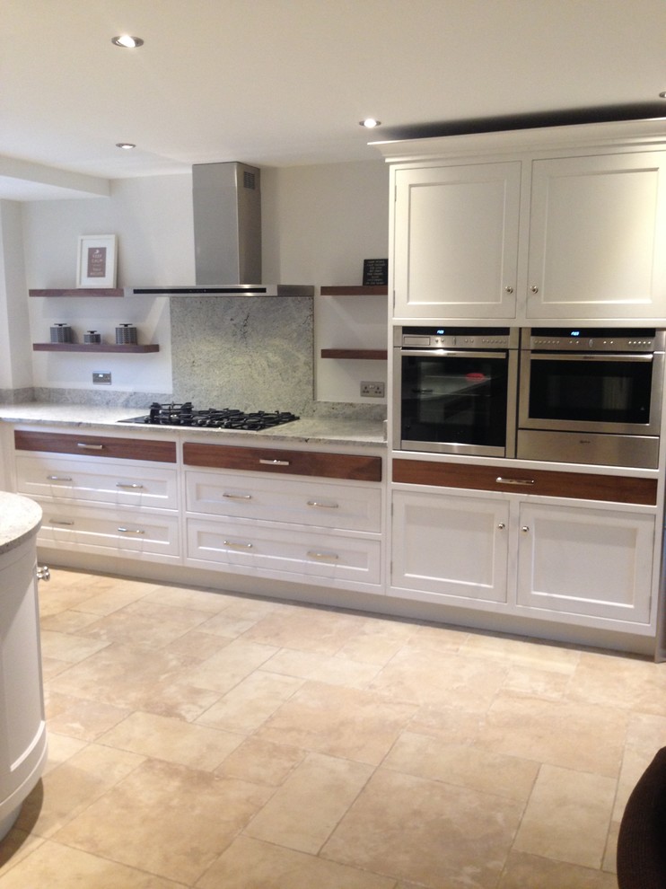 Design ideas for a large traditional u-shaped eat-in kitchen in London with shaker cabinets, white cabinets, granite benchtops, limestone floors and no island.