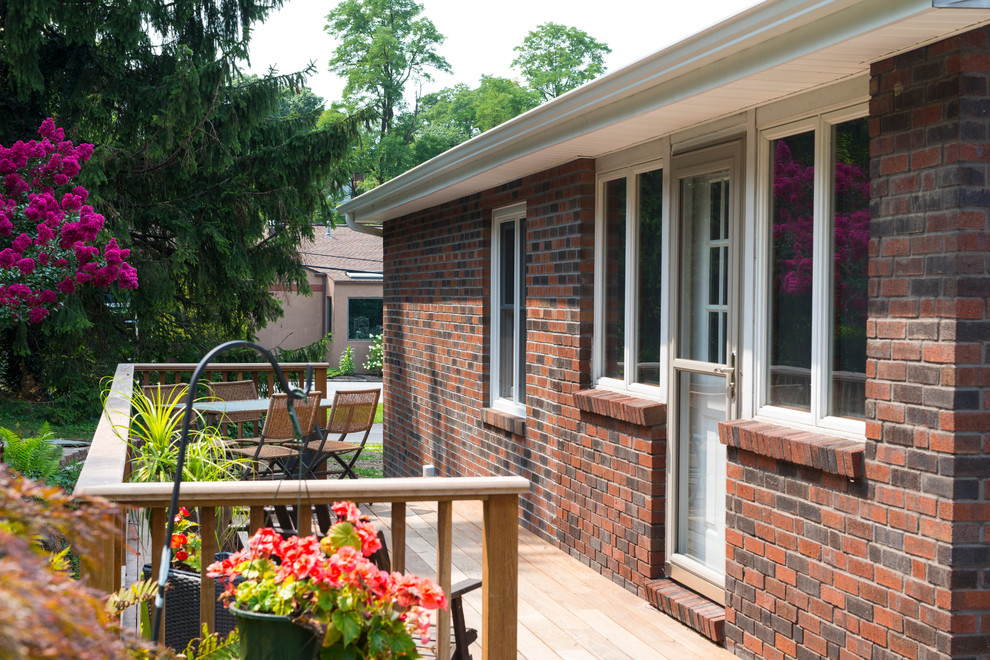 Inspiration for a small transitional backyard deck remodel with no cover