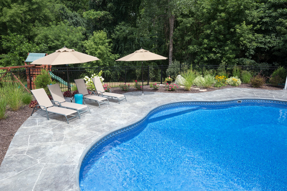 irregular shaped swimming pool with stamped concrete patio Traditional Boston by Dex By Terra