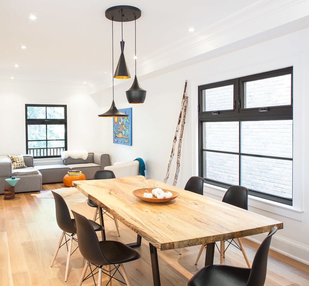 This is an example of a mid-sized contemporary open plan dining in Toronto with white walls and light hardwood floors.