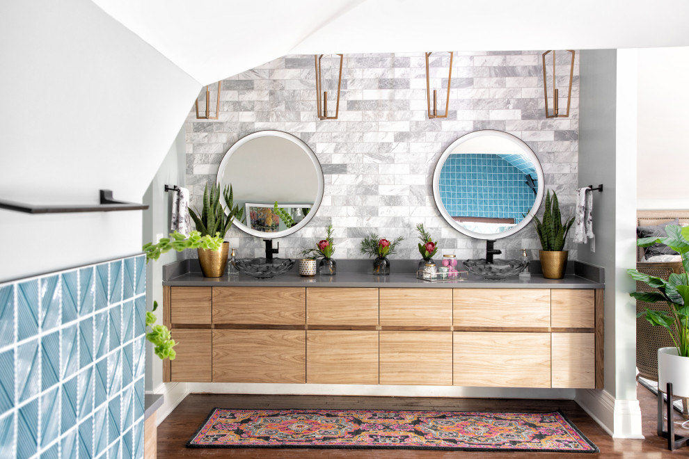 Trendy master multicolored tile and marble tile dark wood floor, brown floor and double-sink bathroom photo in Kansas City with flat-panel cabinets, light wood cabinets, a one-piece toilet, blue walls, a vessel sink, quartz countertops, gray countertops and a floating vanity