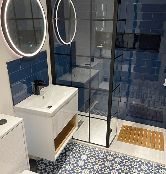 This is an example of a mid-sized contemporary master bathroom in Other with open cabinets, white cabinets, an open shower, blue tile, solid surface benchtops, an open shower, white benchtops, a single vanity and a floating vanity.