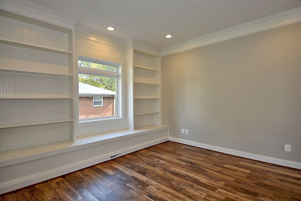 Photo of a mid-sized arts and crafts enclosed living room in DC Metro with a library, grey walls and medium hardwood floors.