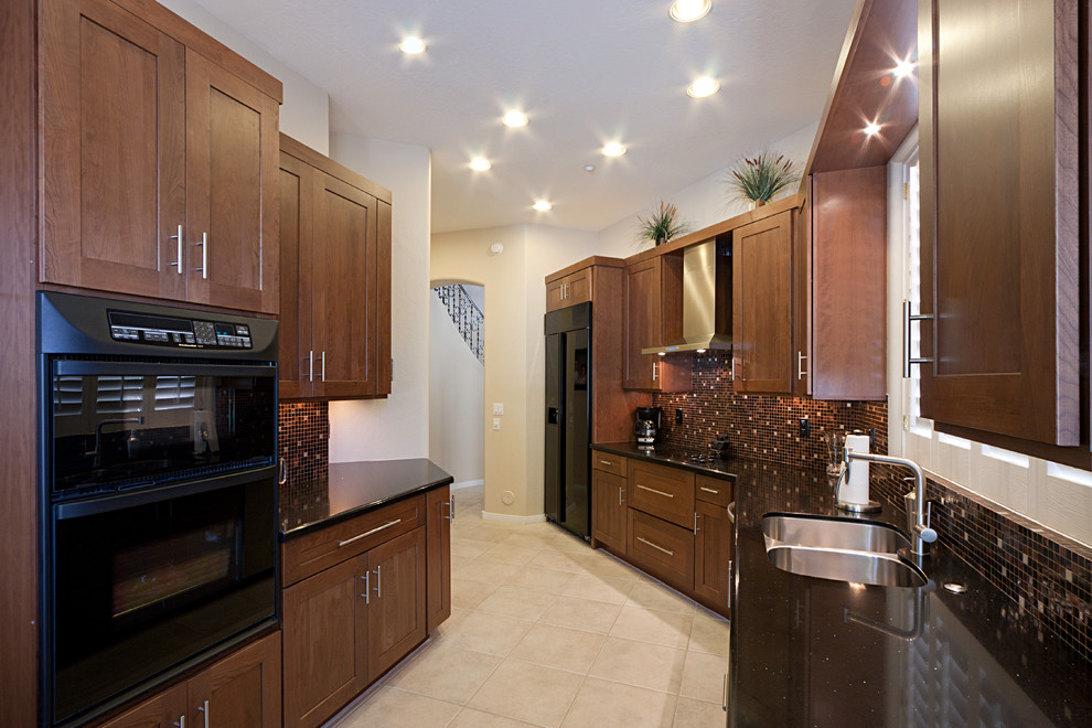 Eat-in kitchen - large transitional ceramic tile eat-in kitchen idea in Phoenix with an undermount sink, flat-panel cabinets, dark wood cabinets, quartz countertops, multicolored backsplash, mosaic tile backsplash, black appliances and no island