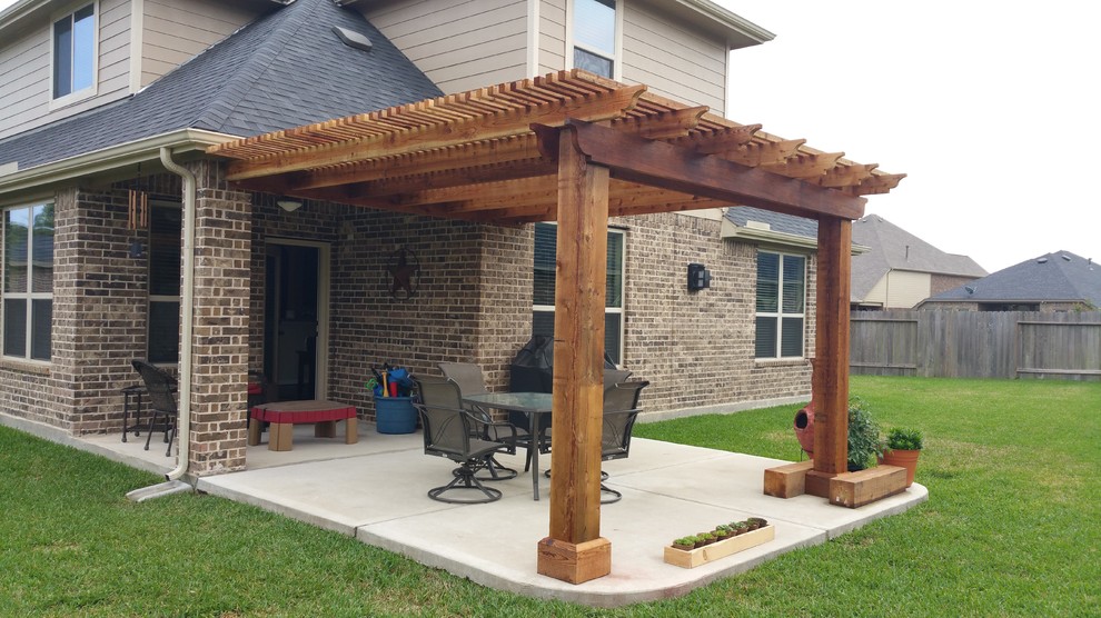 Inspiration for a mid-sized timeless backyard concrete patio remodel in Houston with a pergola