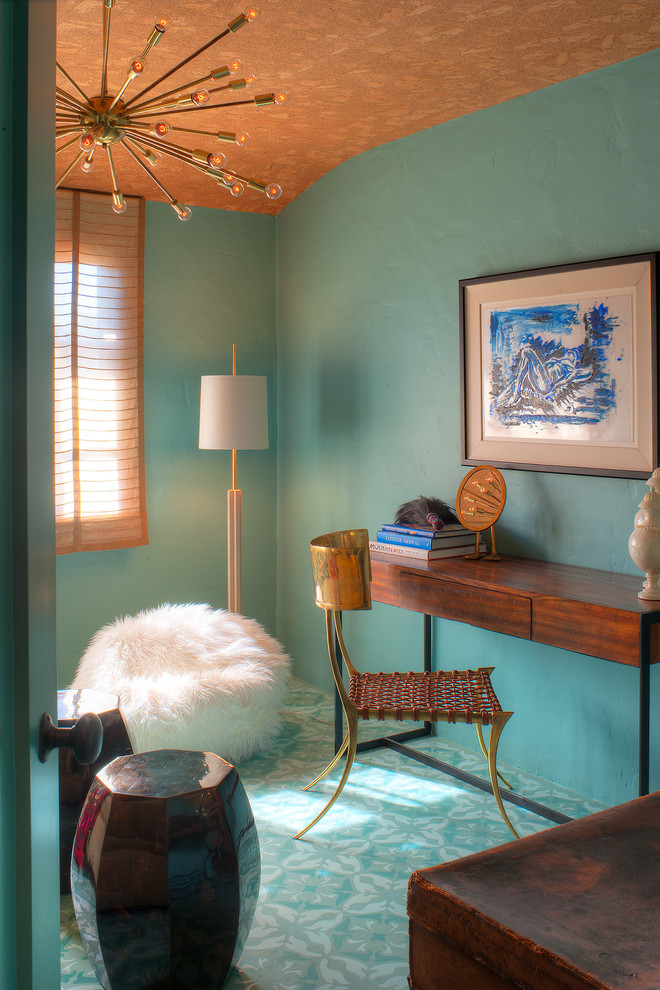 Photo of an eclectic home office in Los Angeles with blue walls, a freestanding desk and turquoise floor.