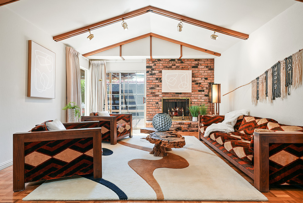 Mid-sized 1950s formal and open concept light wood floor, brown floor and vaulted ceiling living room photo in San Francisco with white walls, a standard fireplace, a brick fireplace and no tv