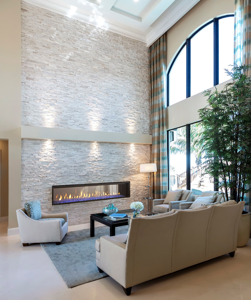 Inspiration for a mid-sized modern formal open concept living room in Houston with beige walls, light hardwood floors, a ribbon fireplace, a stone fireplace surround, beige floor and no tv.
