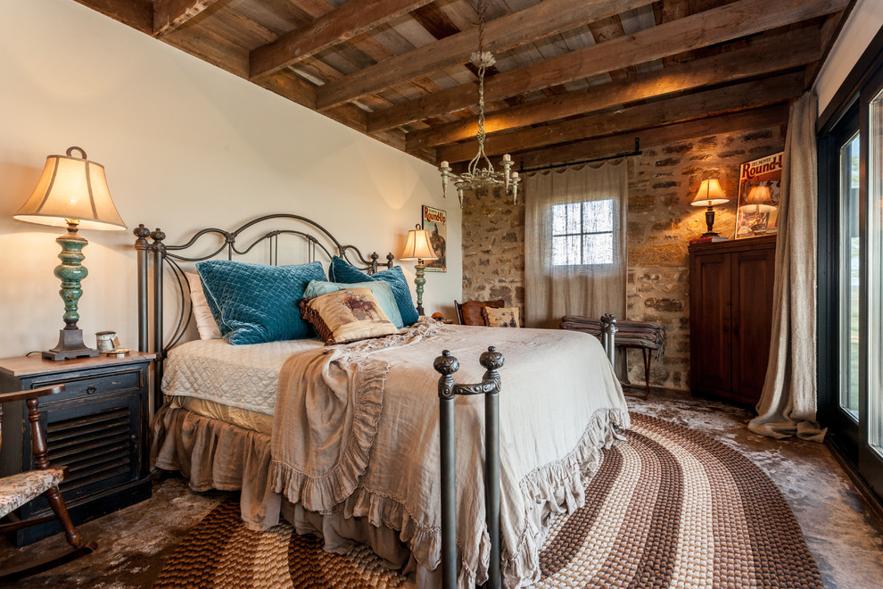 Photo of a country bedroom in Austin with white walls.