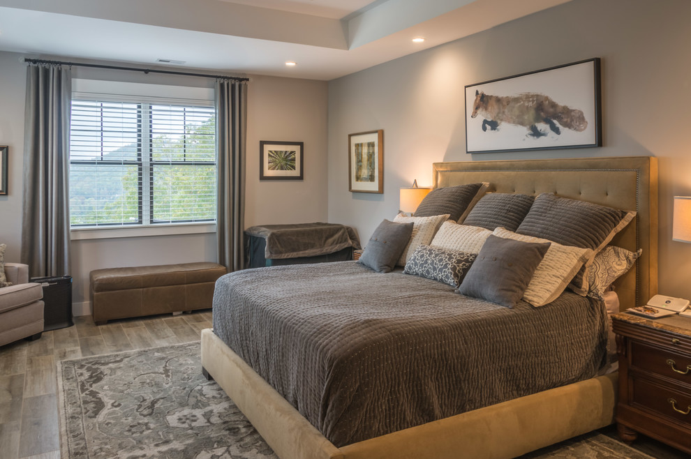 Large transitional master bedroom in Other with grey walls, ceramic floors and brown floor.
